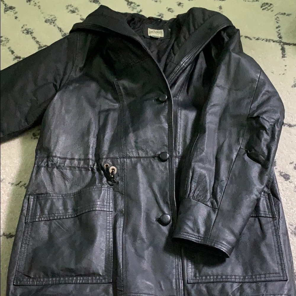 Medium length heavy leather button up coat